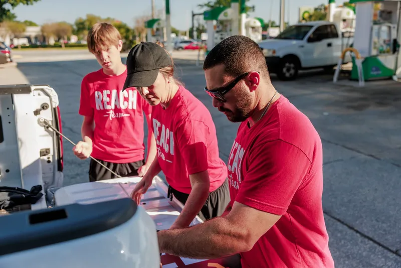 Serve Saturday volunteers in red REACH shirts