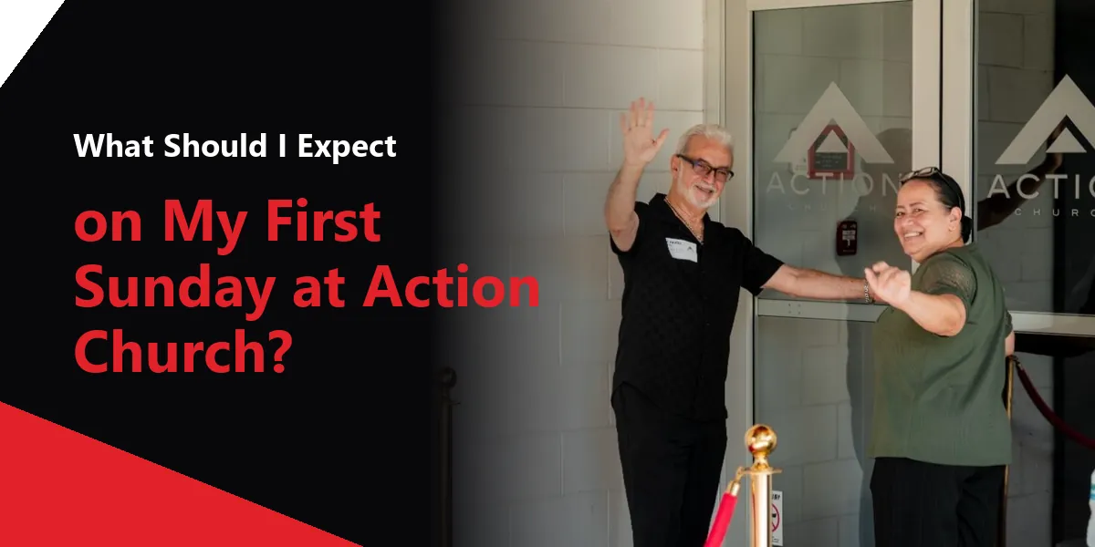 Two Action Church volunteers welcoming guests at the church entrance.